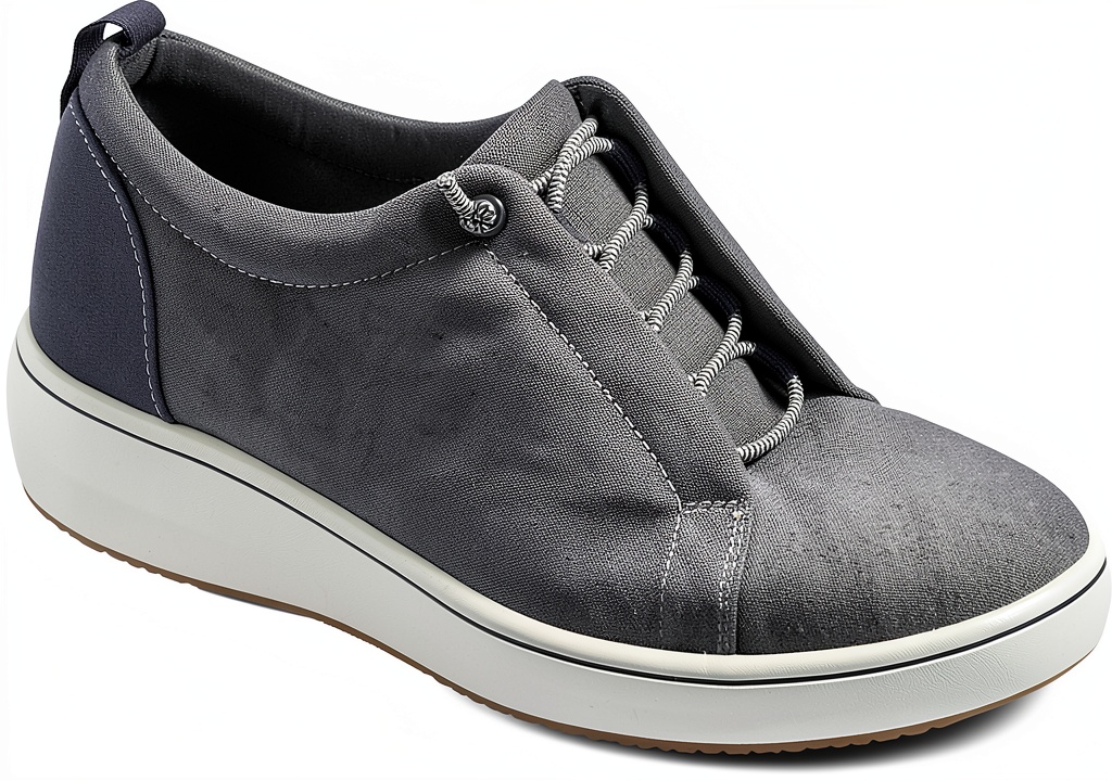 Clarks Womens Oxfords Textile Upper Bungee Laces Comfort being slipped onto a foot on a wooden desk